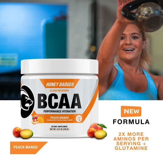 Honey Badger BCAA + EAA mixing glass with Peach Mango flavor for hydration after workouts.