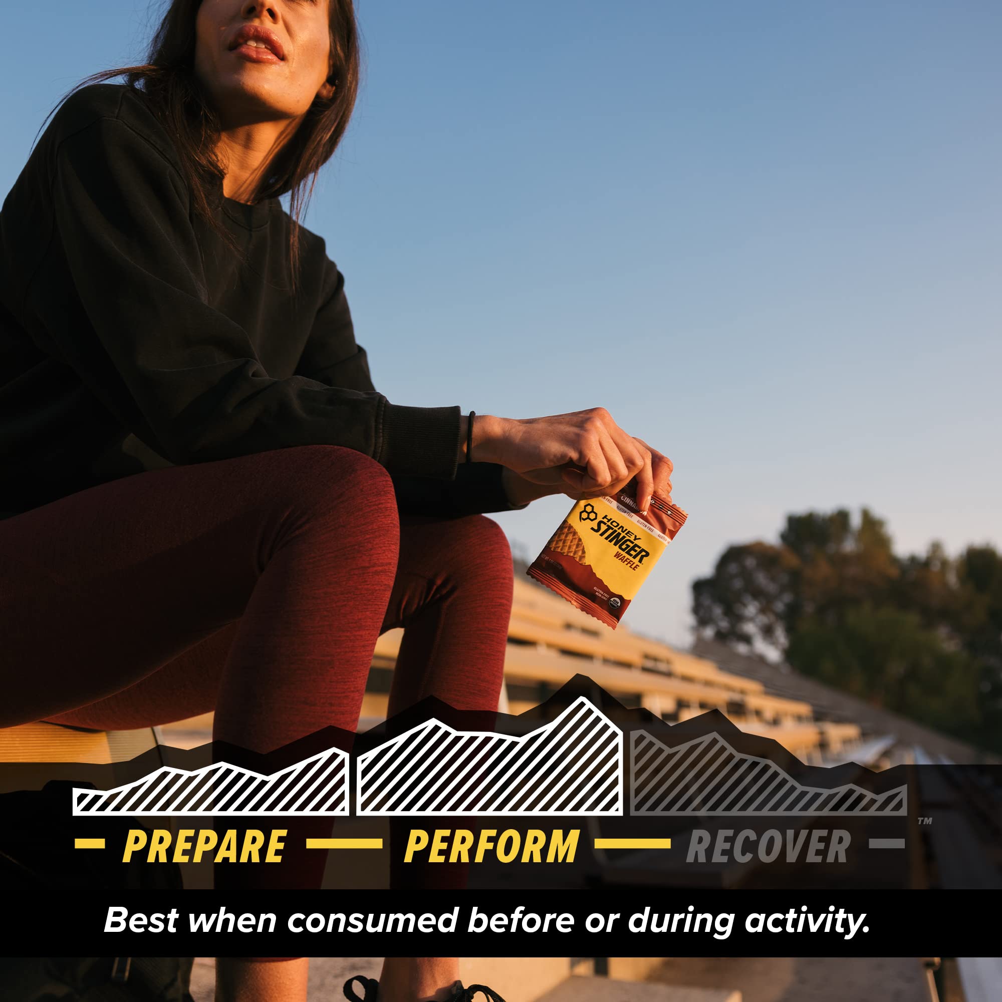 Athlete enjoying a Honey Stinger waffle during a run for portable endurance support.