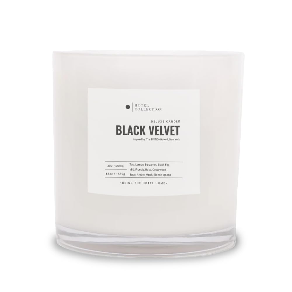 Hotel Collections Black Velvet Deluxe Candle jar glow enhances living room ambiance.