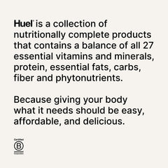Huel bar held in hand, dark chocolate raspberry flavor for on-the-go energy.