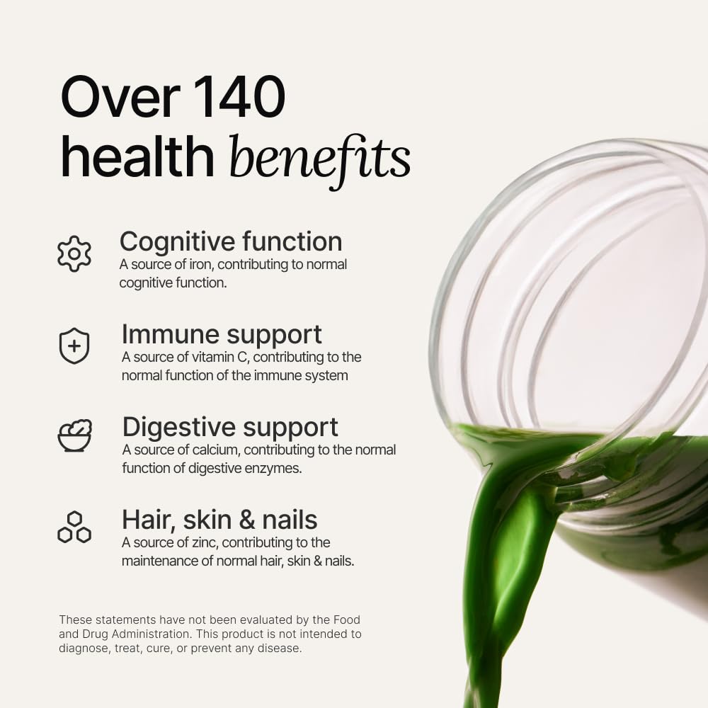 Glass of prepared Huel Daily Greens with a lemon-ginger hue for refreshment