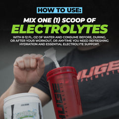A glass of water with Huge Supplements Electrolytes Powder Arctic Lime ready to drink.