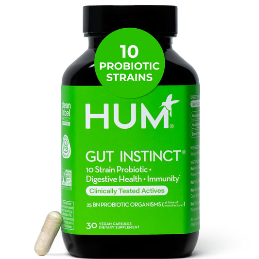 HUM Gut Instinct bottle cap open showing capsules for daily digestive support.