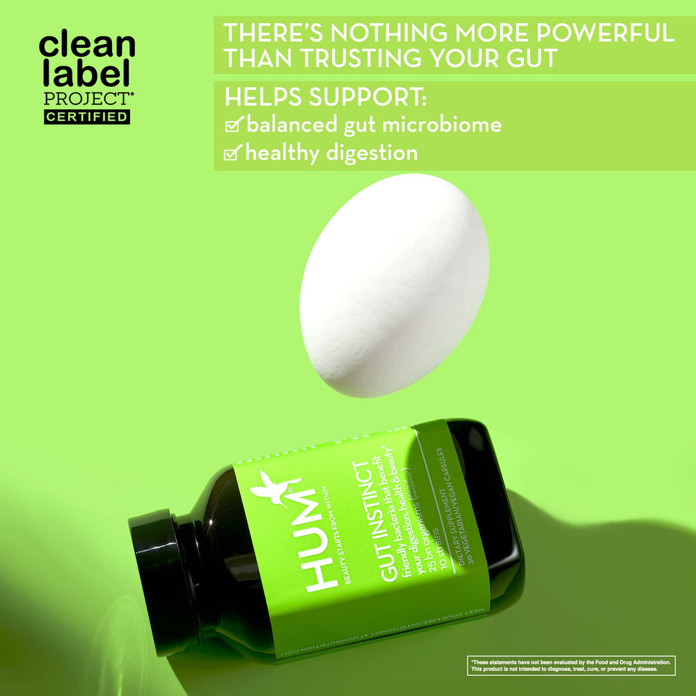 HUM Gut Instinct capsules closeup showing vegan capsules for daily use.