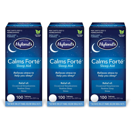 Hyland's Calms Forte sleep aid bottle on nightstand showing natural relief for occasional sleeplessness