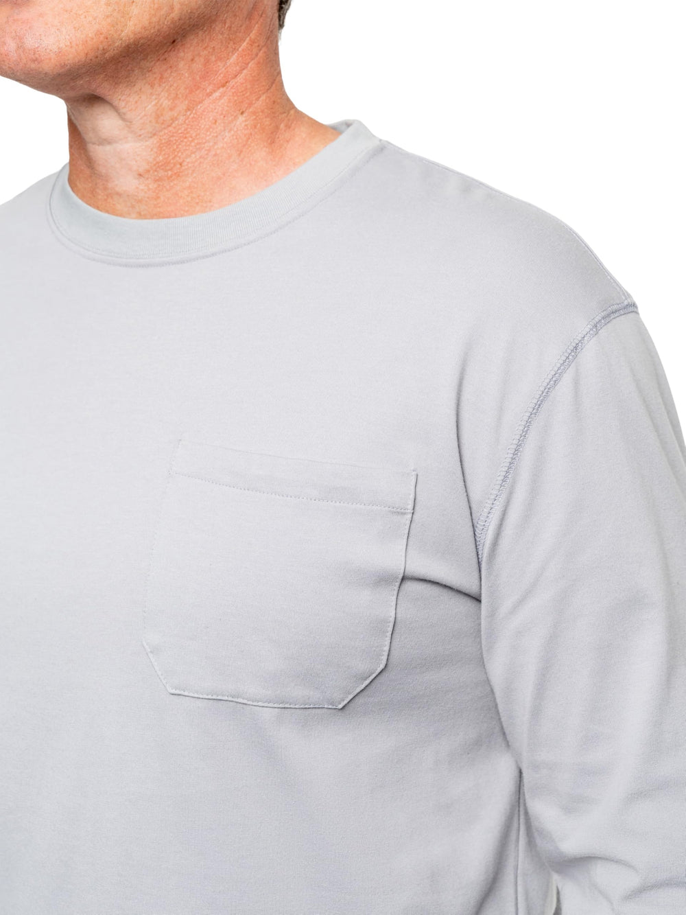 Model wearing Insect Shield pocket tee outdoors highlighting UPF 30+ protection
