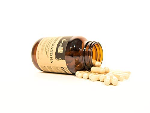 ISHA Ashwagandha supplements on a nightstand for evening routine support.
