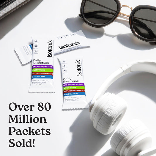Isotonix Daily Essentials packet being poured into water for fast absorption.