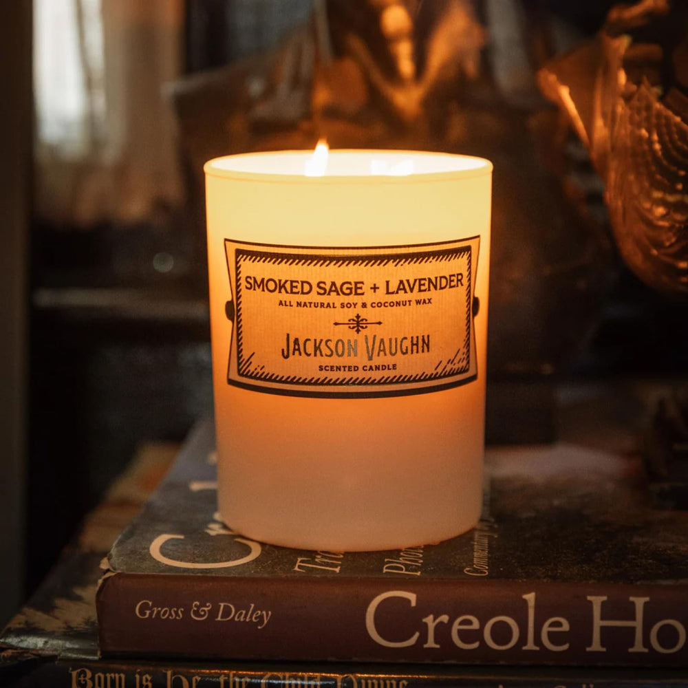 Jackson Vaughn Daily Rituals candle in frosted glass jar glows softly
