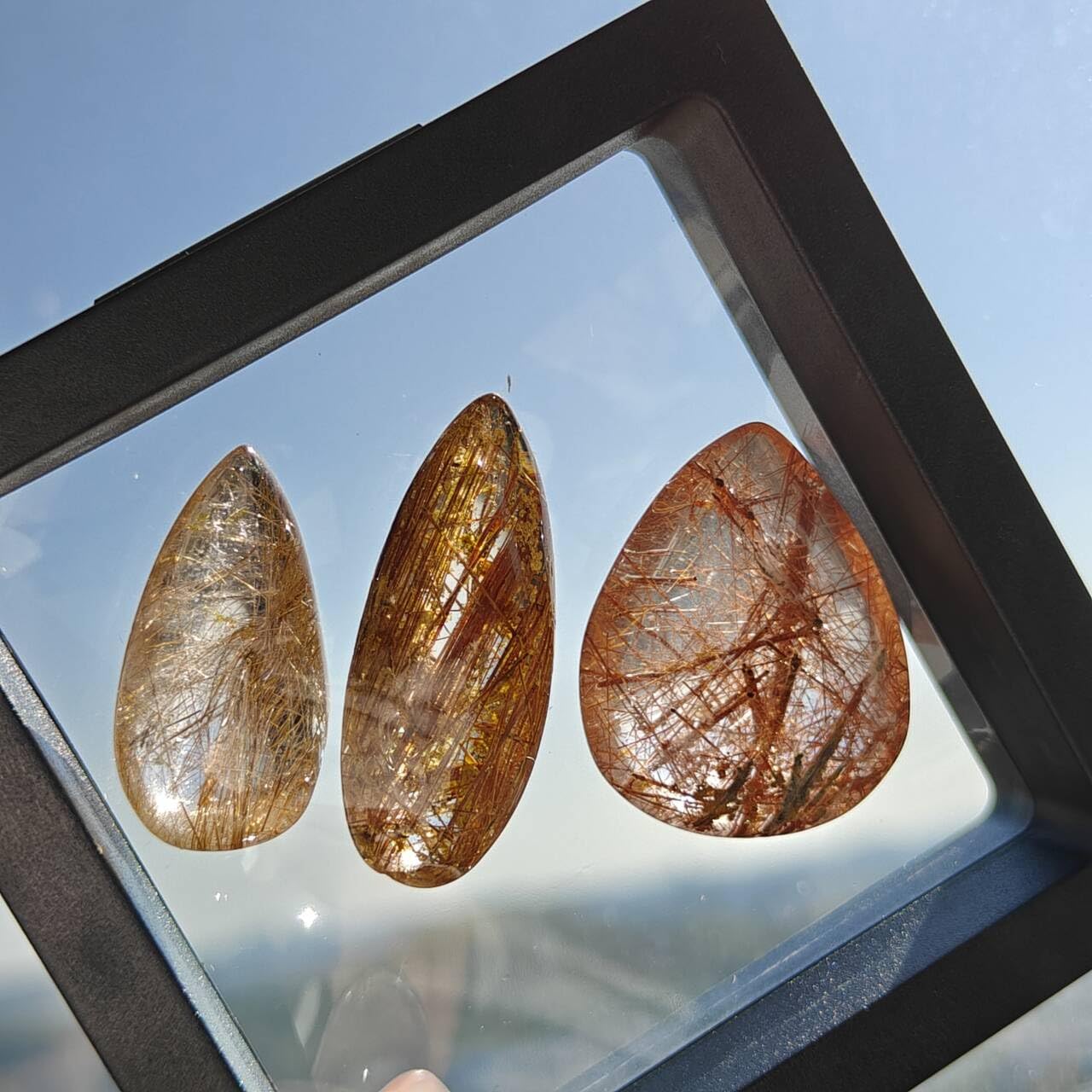 JDFlying rutilated quartz cabochon with dramatic rutile inclusions
