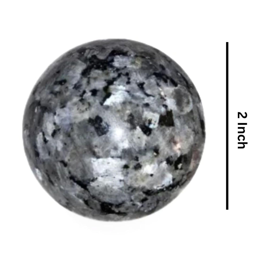 Jet International Larvikite ball held in hand for grounding energy
