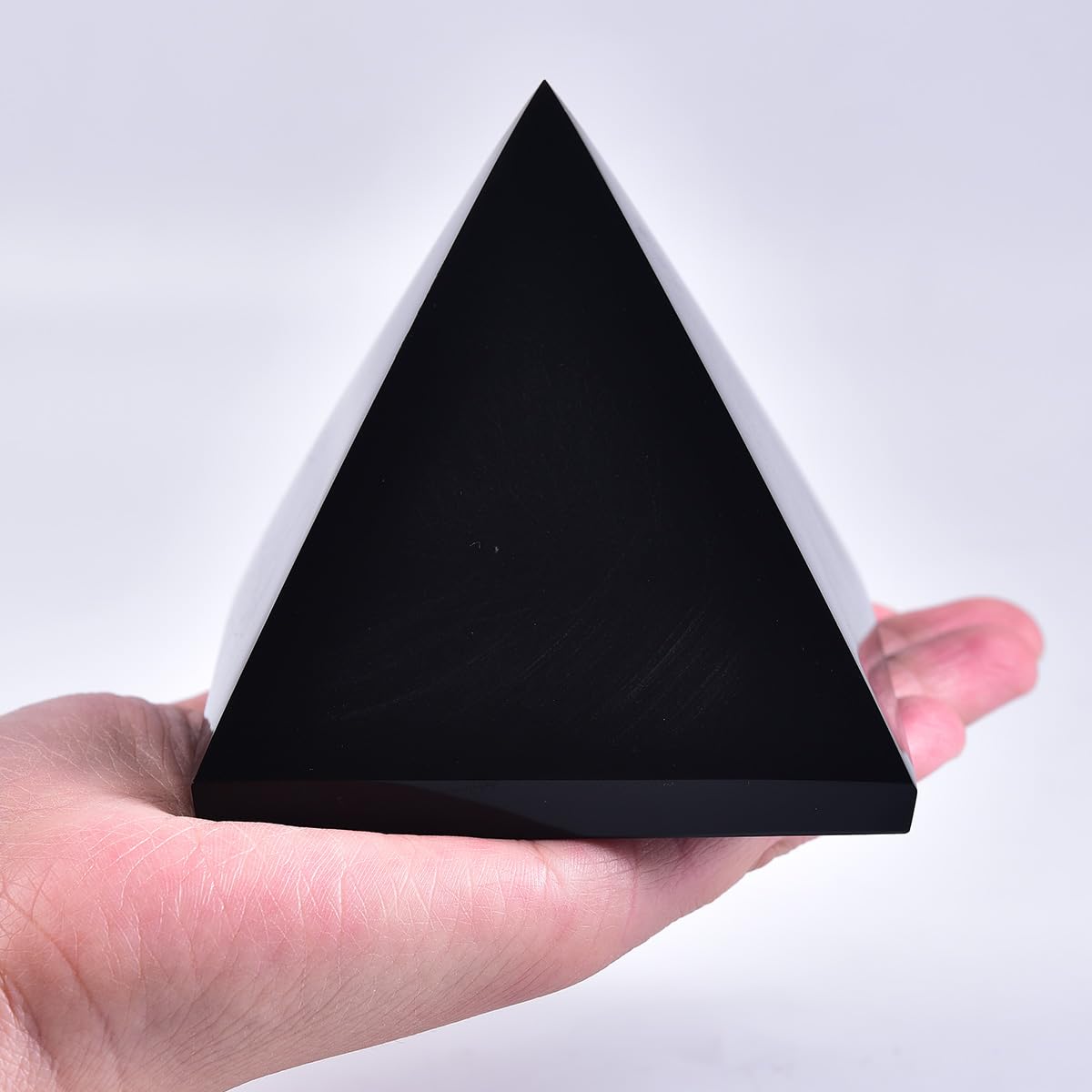 JIC Gem Black Obsidian Pyramid on a desk, creating a calm zen workspace.