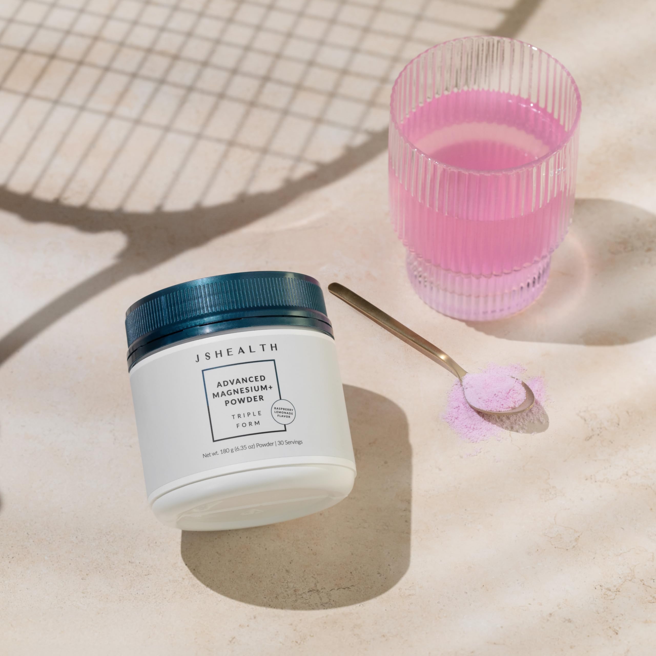 JSHealth Advanced Magnesium+ powder stirred in a glass to create a refreshing relaxation drink