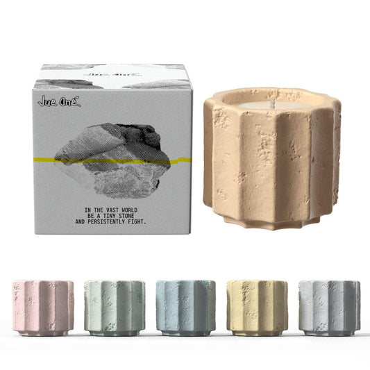 JueOne candles front view in cement jars, adding refined ambience to a living space.