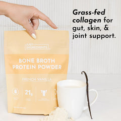 Just Ingredients bone broth protein powder vanilla bottle with glass of milk, premium vanilla flavor.