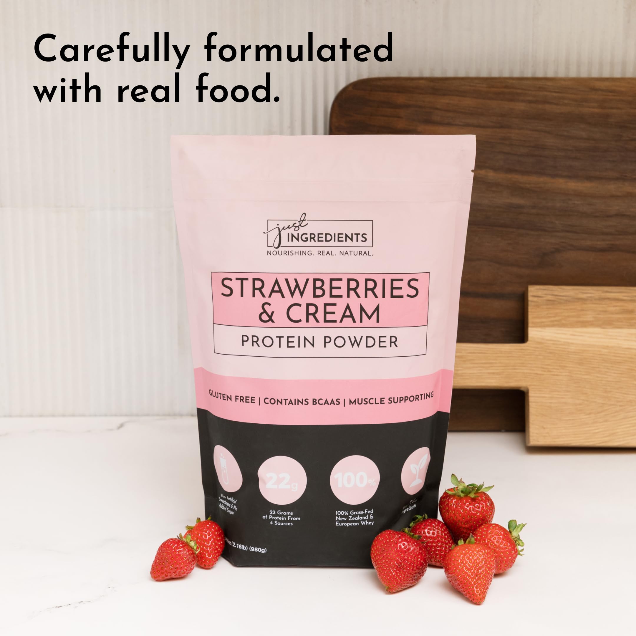 JUST INGREDIENTS Strawberries & Cream Protein Powder with milk glass suggests easy mixing options