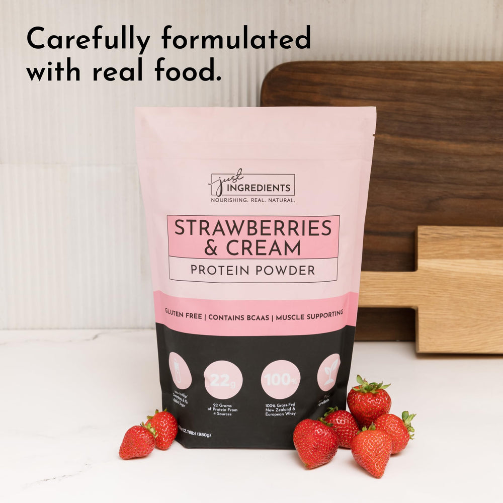 JUST INGREDIENTS Strawberries & Cream Protein Powder with milk glass suggests easy mixing options