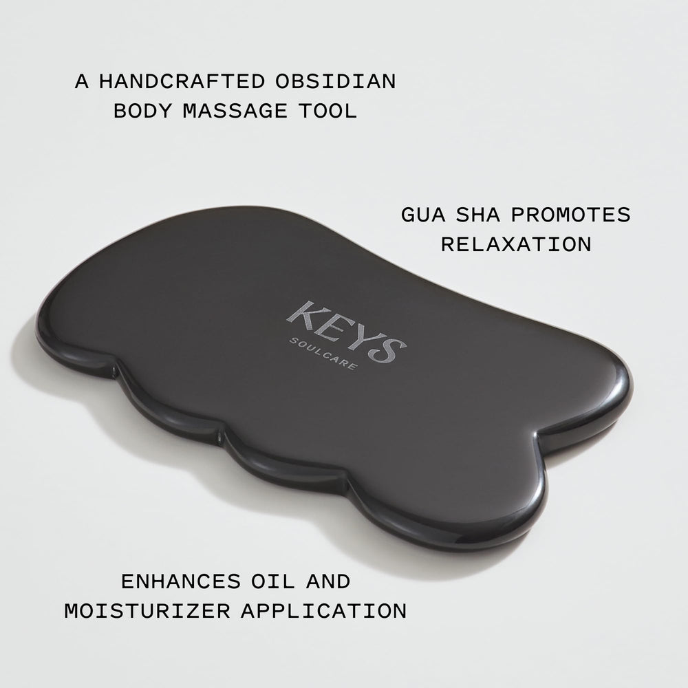 Keys Soulcare Obsidian Stone Gua Sha Tool closeup of the polished obsidian surface.
