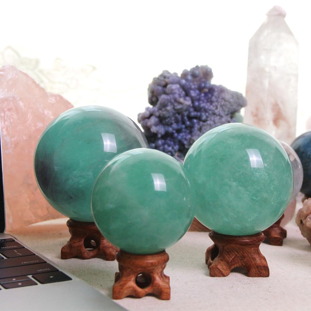 KINO green fluorite sphere as decorative display on a shelf.