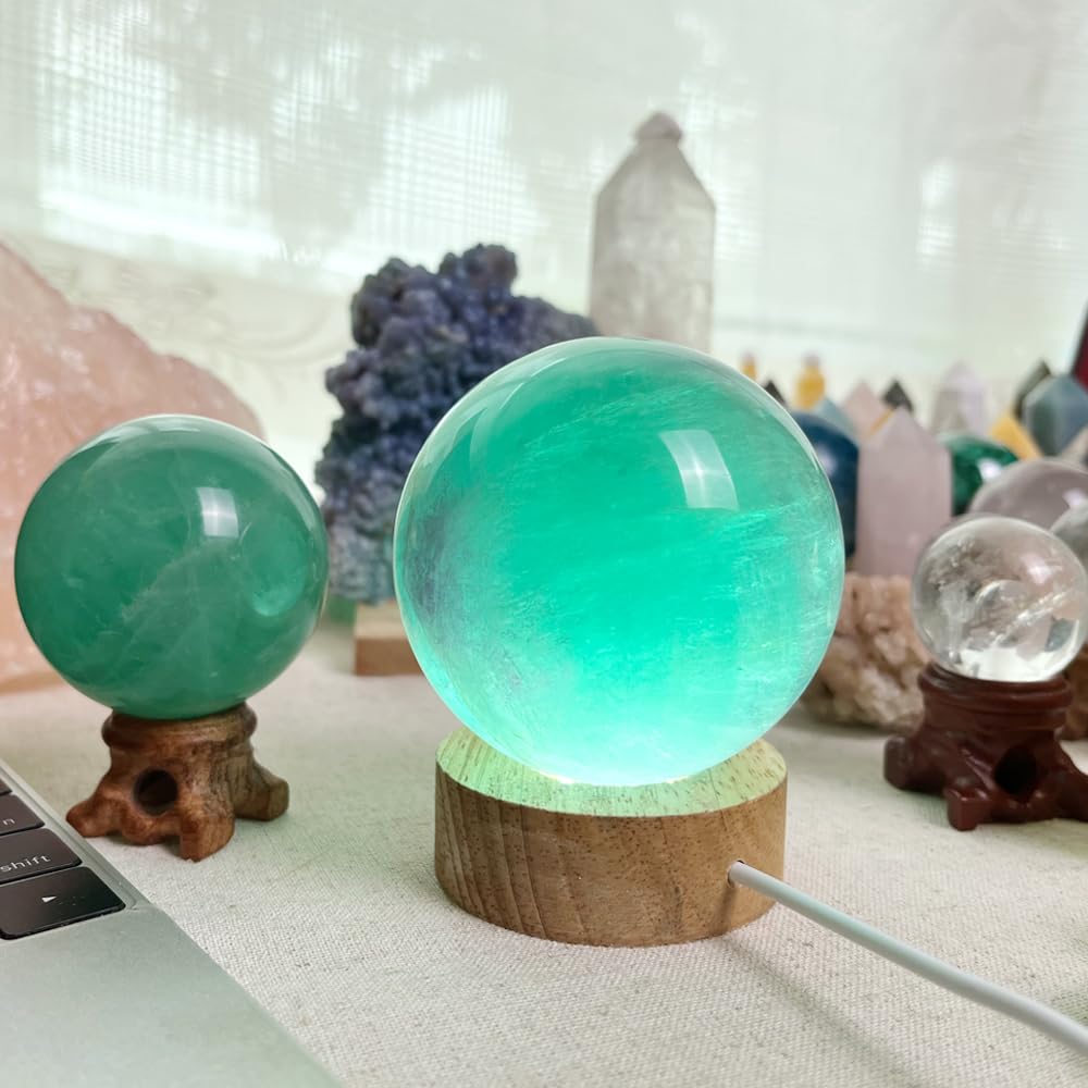 KINO green fluorite sphere demonstrates energy flow in a desk setup.