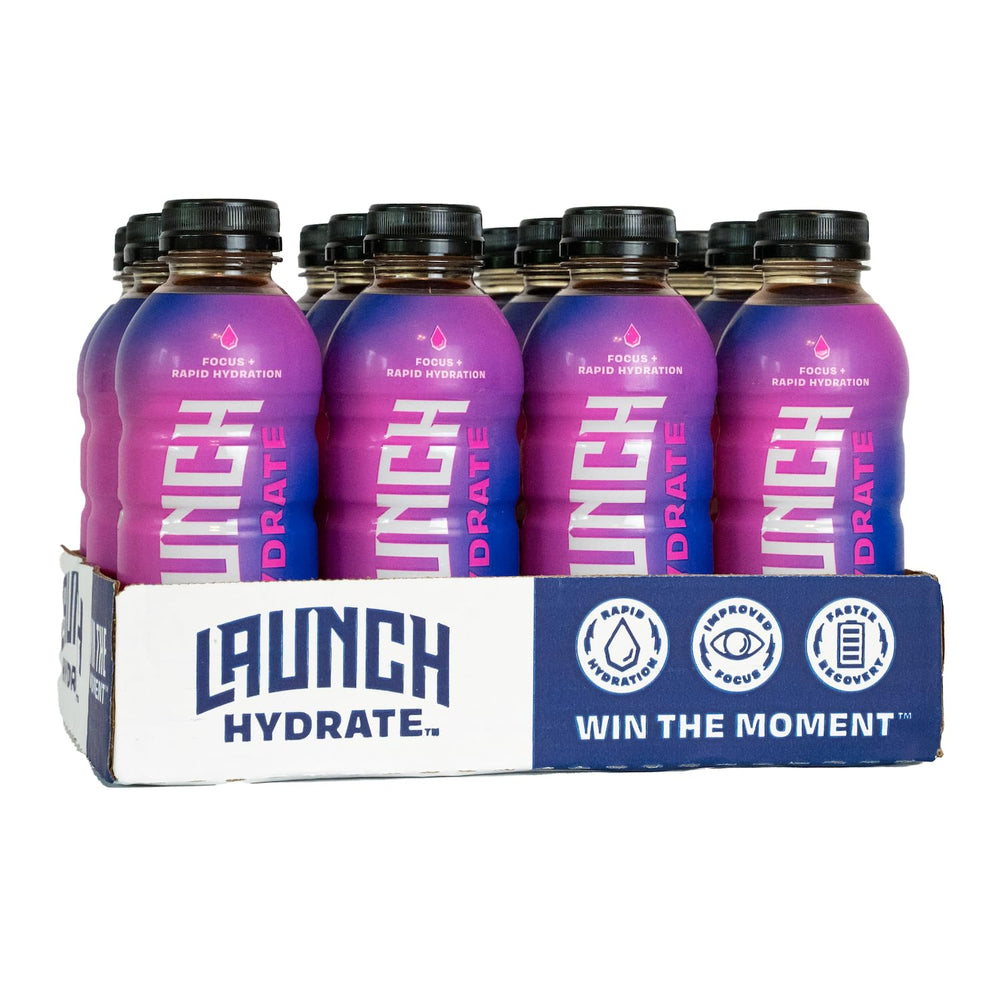 Launch Hydrate strawberry lemon bottle on table showcases refreshing hydration for workouts.