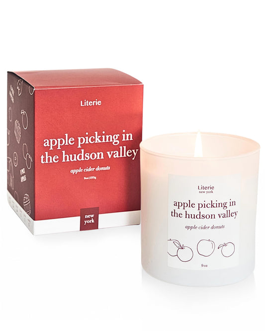 Literie NYC-inspired candle with apple-picking Hudson Valley scene for cozy ambience.