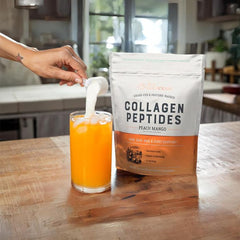 Pouring Live Conscious Peach Mango collagen into a cup for easy mixing