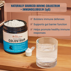 Live Conscious colostrum powder scoop beside bottle for convenient serving.