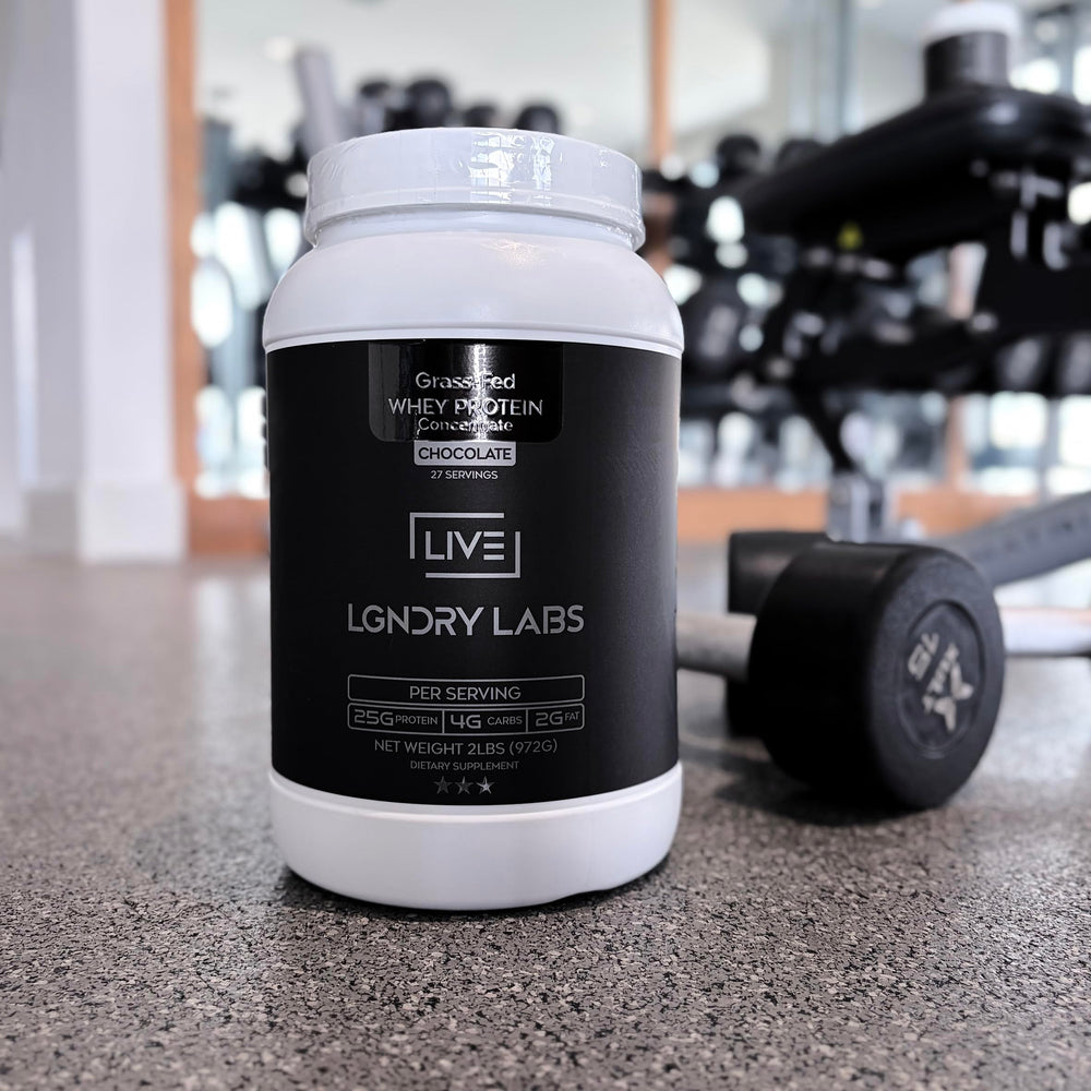 LIVE LGNDRY LABS chocolate whey being poured into a glass for a shake