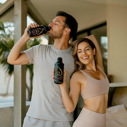 LIVEBOOST daily energy-support liquid poured into glass for focus.