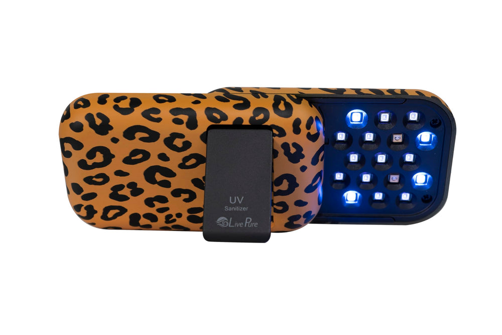 LivePure Leopard handheld UV sanitizer in use on a kitchen counter for quick disinfection.
