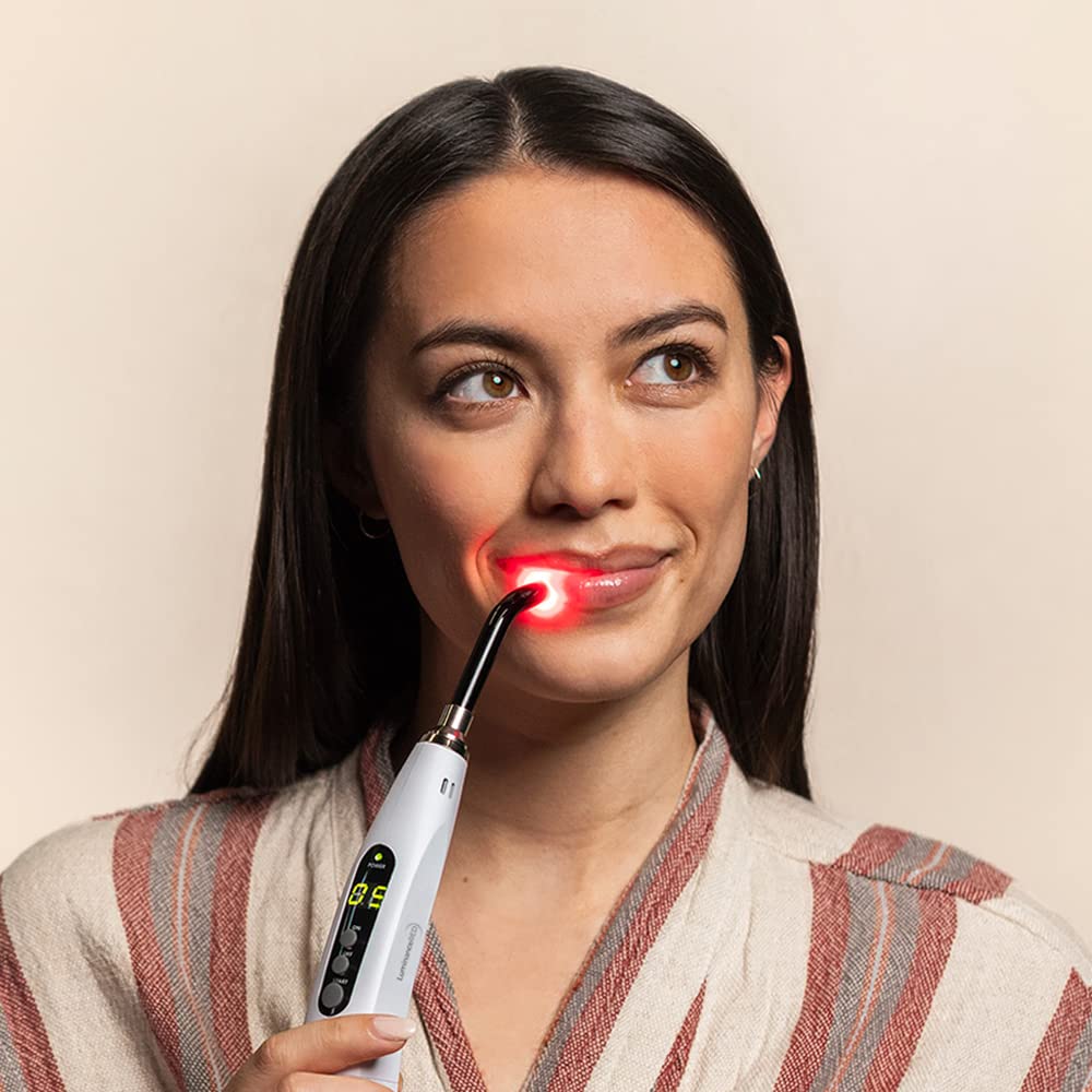 Luminance Red lip sore device close-up label highlights quality and safety features.