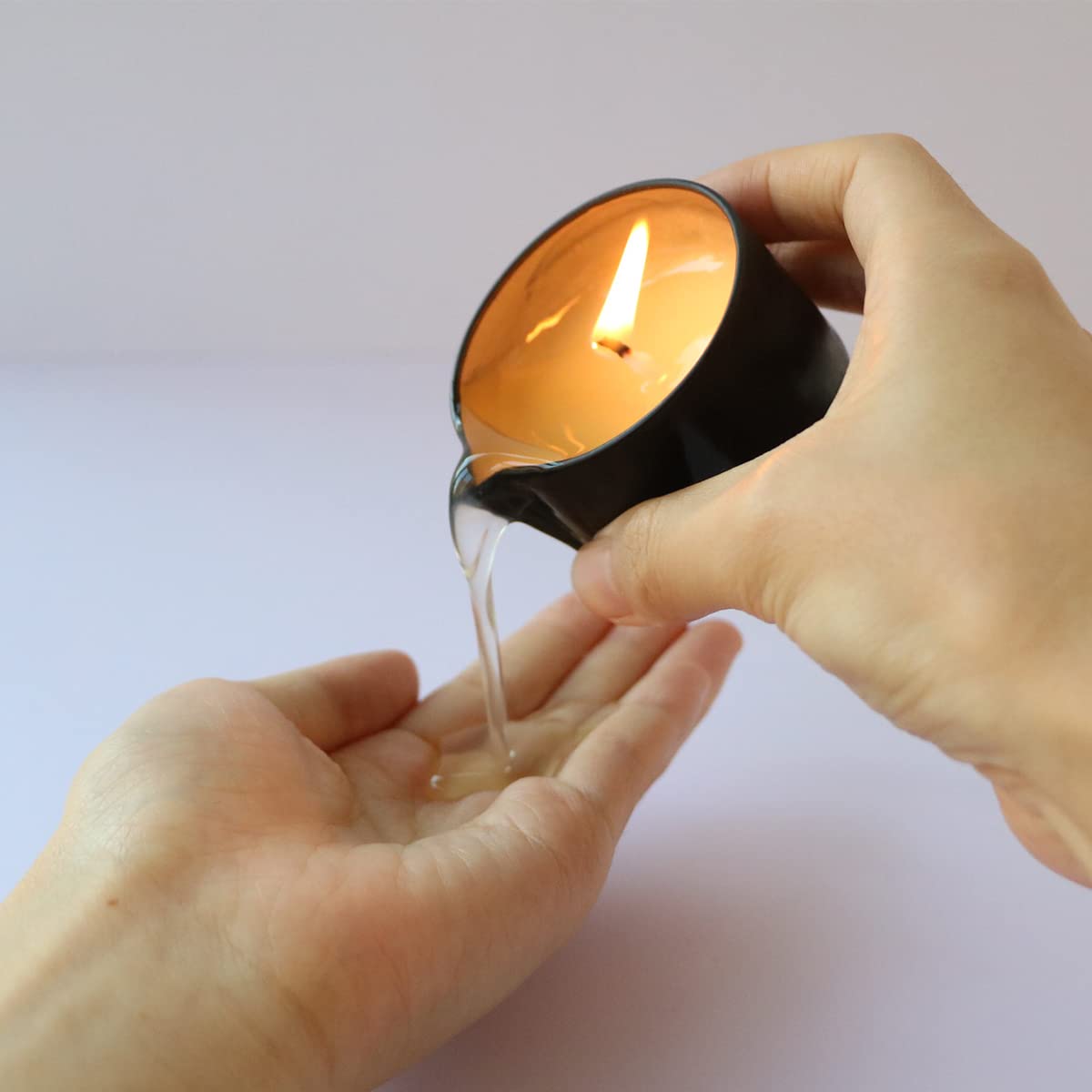 Luxmasa Jasmine massage candle glow releasing aromatic warmth for calm evenings.