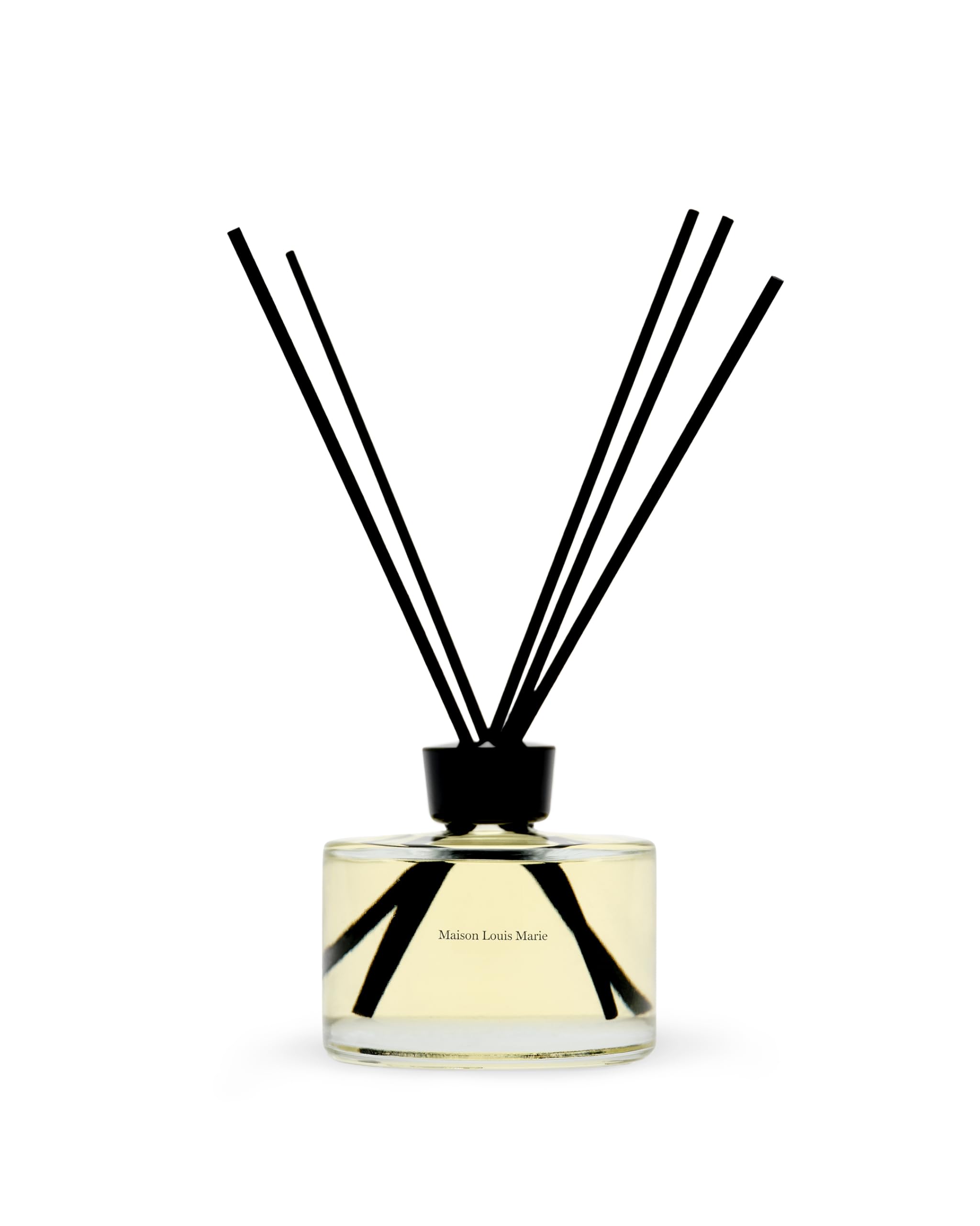 Maison Louis Marie No.09 diffuser bottle on a table releasing a citrus-woody aroma for living spaces