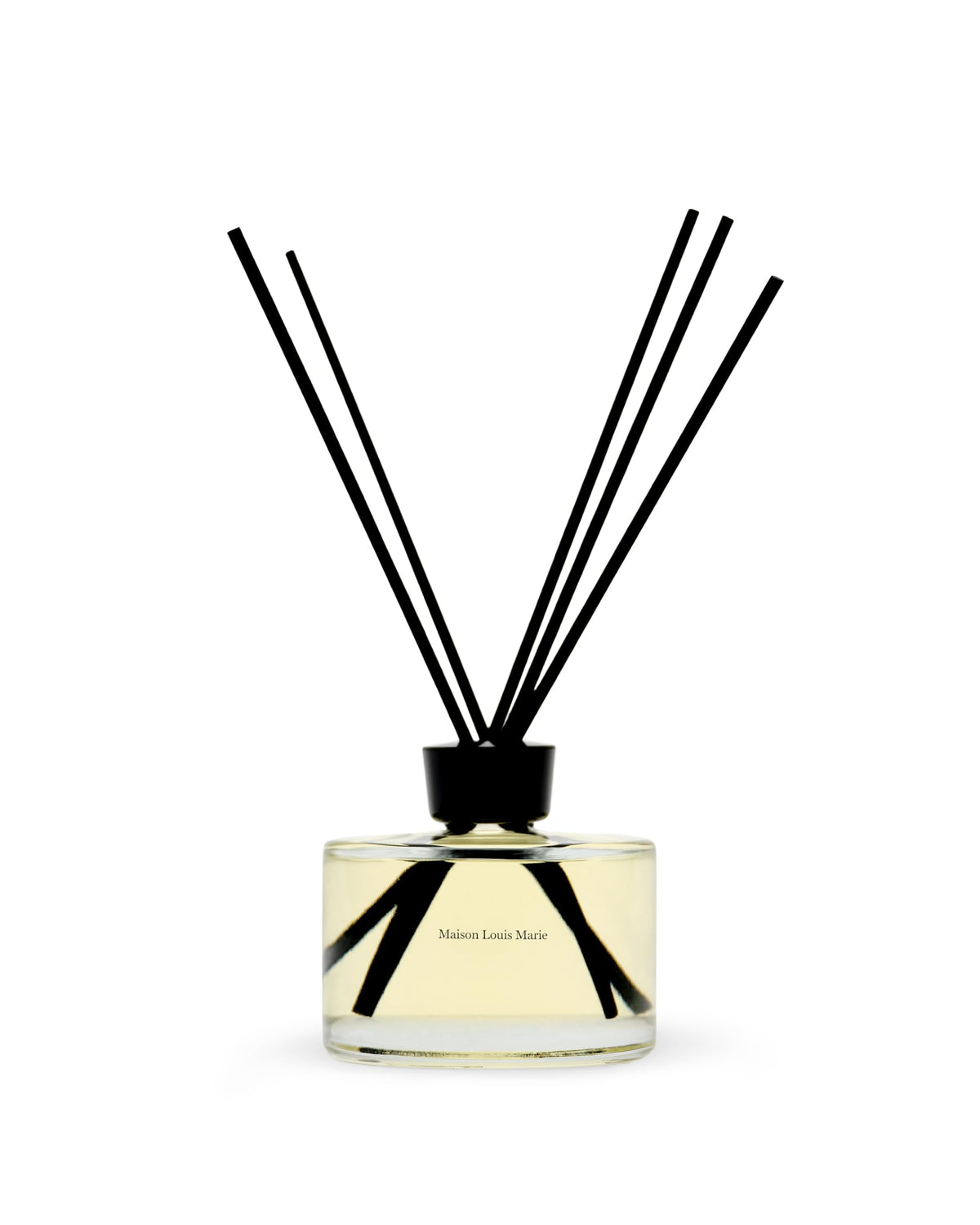 Maison Louis Marie No.09 diffuser bottle on a table releasing a citrus-woody aroma for living spaces
