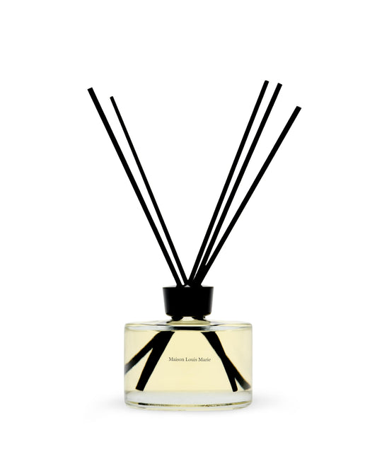 Maison Louis Marie No.09 diffuser bottle on a table releasing a citrus-woody aroma for living spaces