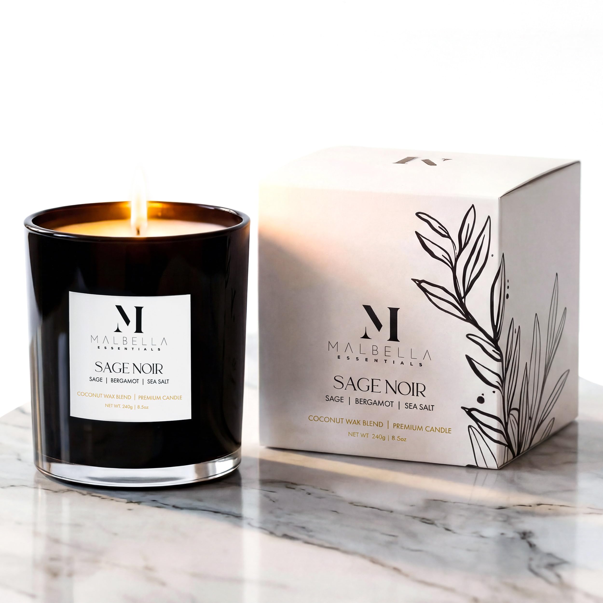 Sage Noire candle in a glossy glass vessel emitting ambient glow by Malbella Essentials.