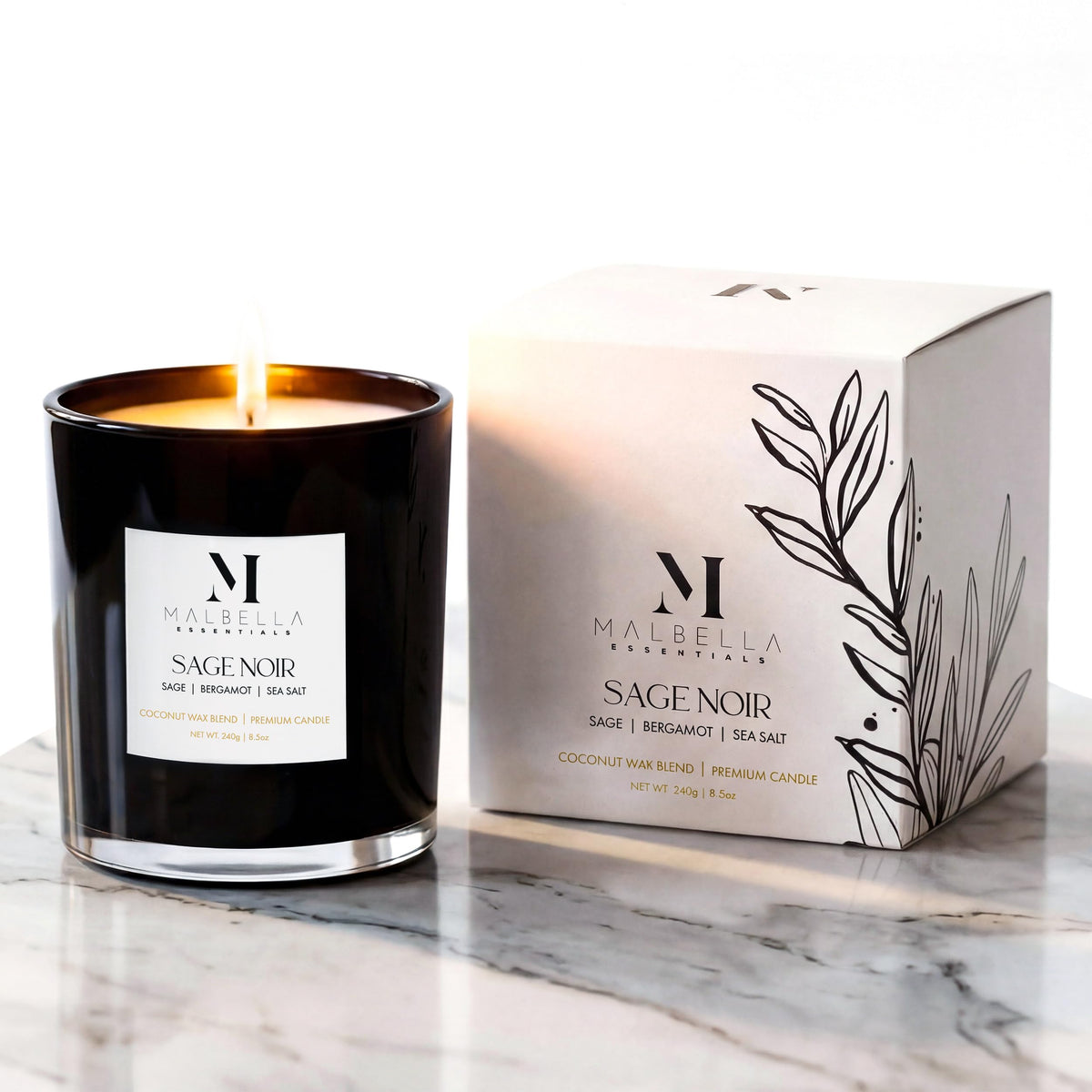 Sage Noire candle in a glossy glass vessel emitting ambient glow by Malbella Essentials.