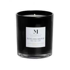 Malbella Essentials Rose Oud Amour candle's clear base showcases warm candlelight.