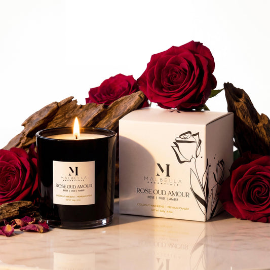 Malbella Essentials Rose Oud Amour candle in matte blush jar delivers a soft, calming glow.