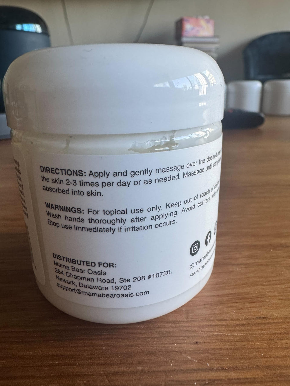 Mama Bear Oasis Magnesium cream being applied to a foot for soothing relief.