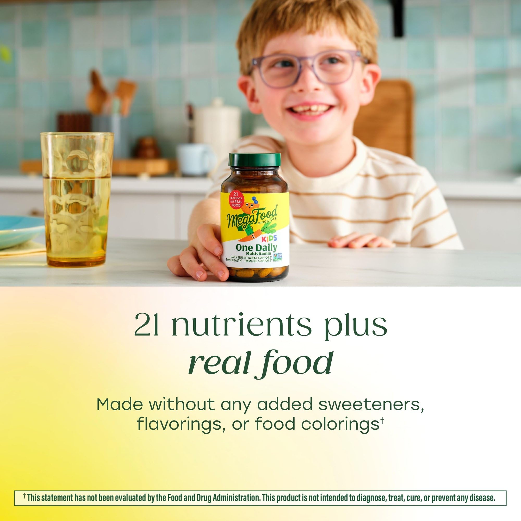 MegaFood Kids One Daily tablet in hand, easy to take on the go.