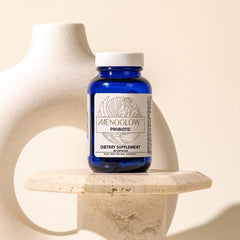 MenoGlow capsules beside a glass of water signaling a simple daily ritual.