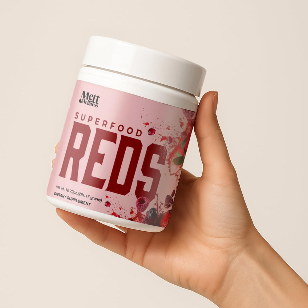 Mett Wellness Reds ready-to-mix powder shown with a glass of prepared drink.