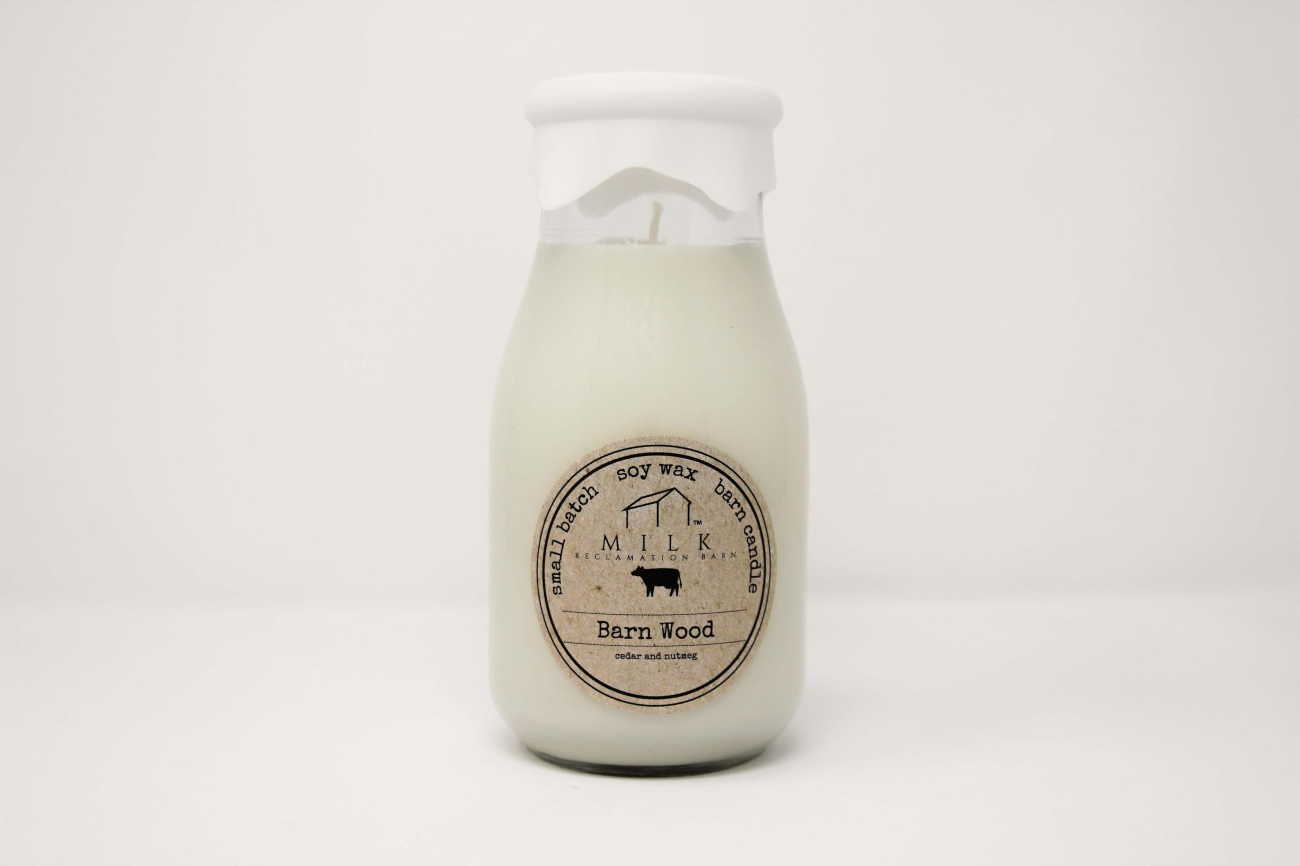 Milk Reclamation Barn milk-bottle candle with barn-wood glow, evoking cozy farmhouse memory