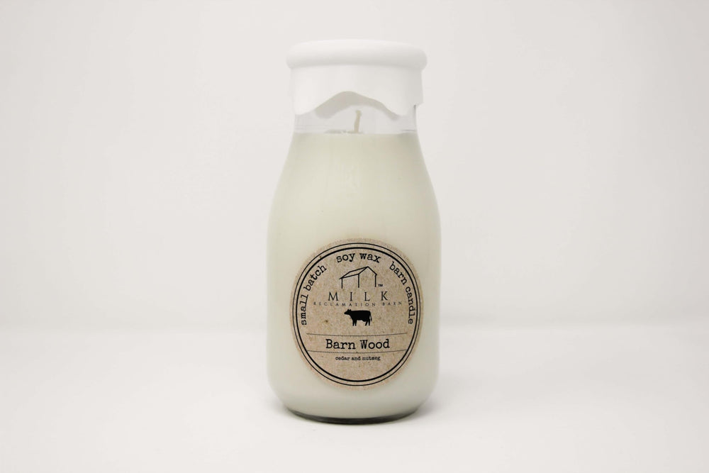 Milk Reclamation Barn milk-bottle candle with barn-wood glow, evoking cozy farmhouse memory