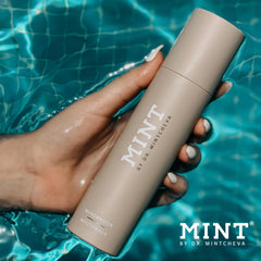 Mint Biotic Mouthwash in a glass for early morning rinse.