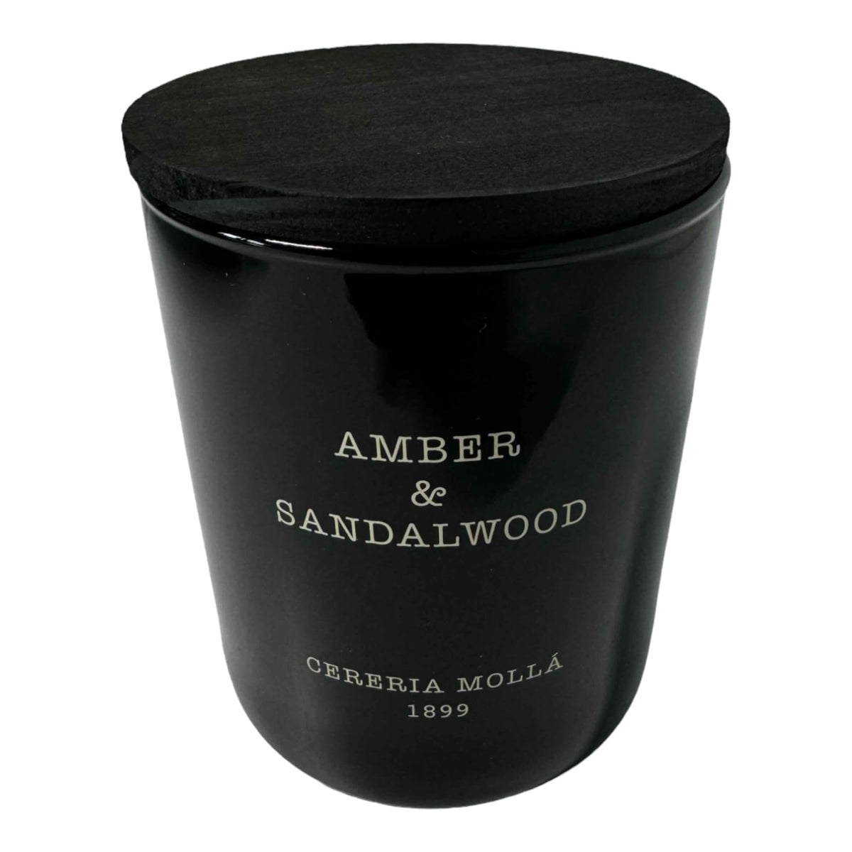 Molla 1899 handmade candle close-up reveals amber-sandalwood fragrance for refined spaces.