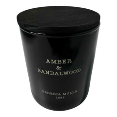 Molla 1899 handmade candle close-up reveals amber-sandalwood fragrance for refined spaces.
