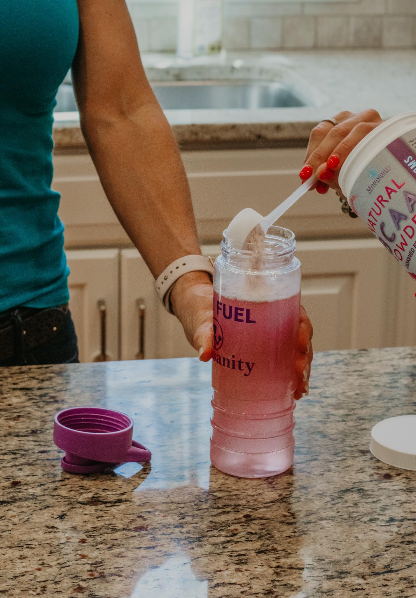 Momsanity BCaa pre-workout ready-to-drink glass after mixing with Raspberry Lemonade.